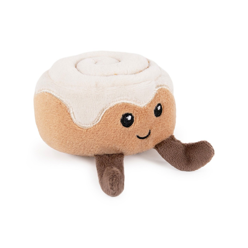 A fabric Cinnamon bun cat toy with stitched face details facing sideways; the bun is topped with white fabric. 
