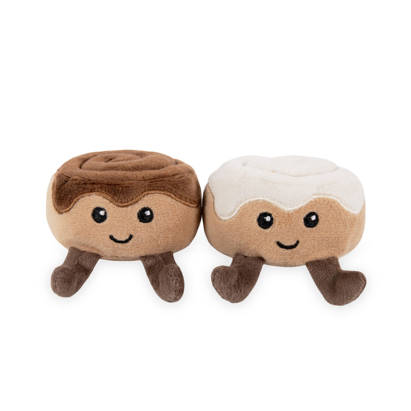 Two fabric Cinnamon bun cat toys with stitched face details facing forward; one is topped with dark brown fabric and the other is topped with white fabric. 