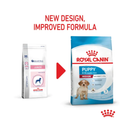 White background with a picture of the old style of Royal Canin Medium Puppy dry food, with new design also shown. 