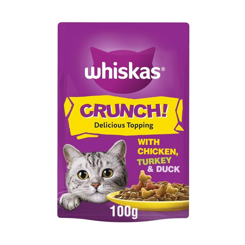 White background with a purple packet of Whiskas Crunch!, on the packet is silver tabby cat's face with a bowl of food pictured. Text on the pack reads 'Whiskas Crunch! Delicious Topping, with Chicken, Turkey & Duck.' 