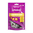 White background with a purple packet of Whiskas Groom & Care Treats, on the packet is silver tabby cat's face under a purple blanket. Text on the pack reads 'Whiskas Groom & Care, with Zinc & Omega-6 for Skin & Coat.' 