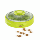 UFO shaped treat dispenser with green central and top parts with main body in grey with biscuits pouring out sat on a white background. 
