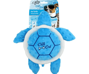Blue and white turtle dog toy with stitch detail of a dog bone and text 'Chill Out' on it's shell, packaged onto cardboard backing. On a white background.