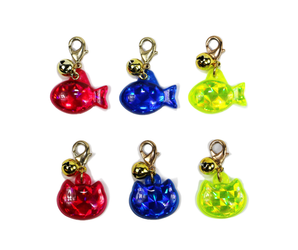 White background with two rows of three reflective reflective ID tags three fish shaped and three cat shaped, in blue, yellow and red.