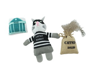 An Ancol plush cat-shaped toy dressed as a bandit with a black-and-white striped shirt, shown with a small burlap sack labeled 'CATNIP 50LBS' and a teal-and white bank box on a plain white background.