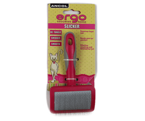White background with a pink and grey Ergo Slicker Bristle Brush for cats, attached to a cardboard backing. 