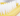 White background with a close up of a small Ancol yellow brush with white bristles for rabbits. 