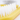 White background with a close up of a small Ancol yellow brush with white bristles for rabbits. 