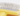 White background with a close up of a  small animal Ancol yellow slicker brush with white tipped metal bristles. 