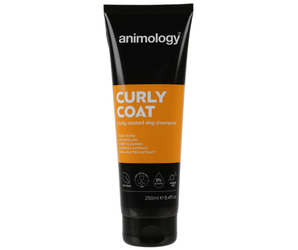 White background with a black and orange bottle of Animology Curly Coat Shampoo. On the bottle is white text 'Animology Curly Coat, Curly coated dog shampoo'. 