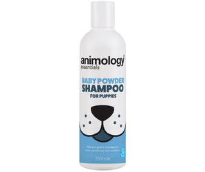 White background with a white and blue 250ml bottle of Animology Essentials Baby Powder Shampoo for Puppies. On the bottle is an illustrated muzzle with white text below 'Mild and gentle shampoo to clean, deodorise and condition.' 