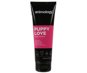 White background with a black and pink  bottle of Animology Puppy Love Shampoo. On the bottle is white text 'Animology Puppy Love, Puppy shampoo'. 