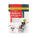 White background with a packet of Antinol Joint Care Pro for Dogs, the packet has red and grey ascents with a Border Collie dog and a Jack Russel terrier pictured. Additional text on the packet states '100% Natural, Supports Joint Health and Mobility, For healthy skin and a shiny coat, Supports natural anti-inflammatory processes, Free from powders and fillers'.