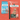 Two Arden Grange dog food packages on a soft red background, demonstrating the recent change in packaging.