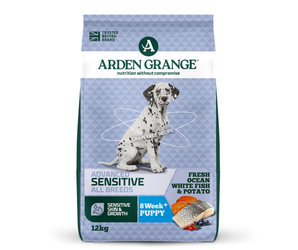 A 12kg bag of Arden Grange Advanced Sensitive All Breeds dog food for 8-week+ puppies, featuring a Dalmatian puppy on the front of a light blue patterned bag.