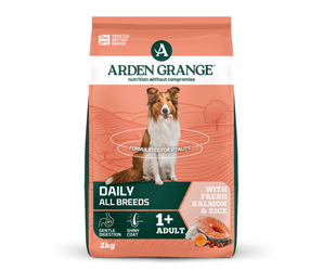 A 2kg bag of Arden Grange, Daily, All Breeds dog food, featuring a salmon and rice flavour. The packaging is coral orange with dark green and white sections, featuring a picture of a collie dog in the centre.