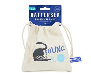 White background with a Battersea canvas pouch of Pounce Cat Balls pictured attached to a blue cardboard tag. 