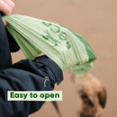Green reusable bag with text 'Easy to open' held by a person, with a blurred background