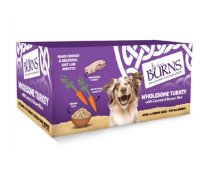 White background with a purple box of Burns Wholesome Turkey Wet Dog Food made with Carrots & Brown Rice. Pictured on the box is a marl collie dog with illustrations of turkey pieces, carrots and a bowl of rice. 