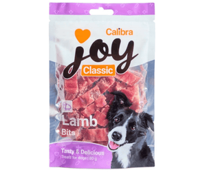 A package of Calibra Joy Classic Lamb Bits dog treats, featuring a white and purple stand-up pouch with a photo of a black and white dog on the front.