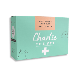 White background with a green box of a Charlie the Vet Pet First Aid Kit Refill Pack, on the box is an illustrated cat and dog. 