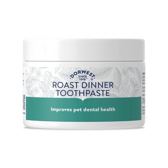 White background with a white and green tub of Dorwest Roast Dinner toothpaste, on the tub is text stating 'Improves pet dental health'. 