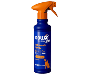 White background with a blue bottle of Douxo Ultra-safe Detangling Spray with an orange spray pump. 