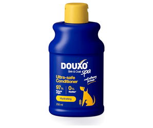White background with a blue bottle of Douxo Ultra-safe Oatmeal Shampoo  with yellow cap.