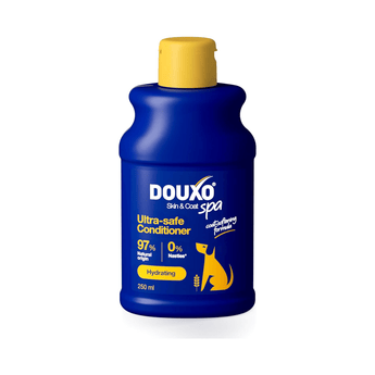 White background with a blue bottle of Douxo Ultra-safe Oatmeal Shampoo  with yellow cap.