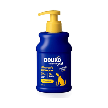 White background with a blue bottle of Douxo Ultra-safe Oatmeal Shampoo  with yellow pump. 