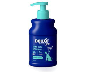 White background with a blue bottle of Douxo Ultra-safe Odour Control Shampoo with aqua blue pump. 
