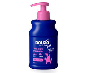 White background with a blue bottle of Douxo Ultra-safe Itch Soothing Shampoo with pink pump. 