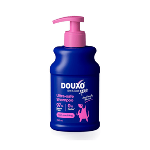 White background with a blue bottle of Douxo Ultra-safe Itch Soothing Shampoo with pink pump. 