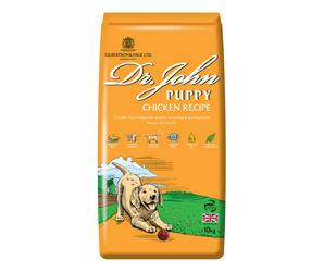 White background with an orange bag of Dr.John Puppy Chicken recipe dry food. Pictured on the bag is an illustrated Labrador puppy in a farm field. 