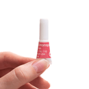 Hand holding a small bottle labeled 'Bronspan' on a white background