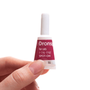 Dronse spot-on treatment for cats held in a hand against a white background