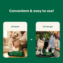 Green background with white text 'Convenient & easy to use!' with two images below: one with a white dog sat on a sofa while their owner reaches for a Earth Rated Dog grooming wipe with text 'At home' and the other of a black and white dog sat in the boot of a car while their owner pulls a wipe from a packet with text 'On the go!' 