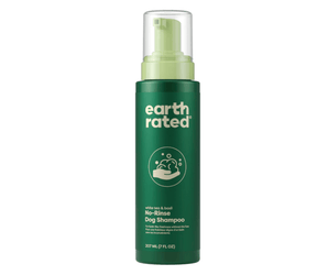 White background with a green pump bottle of Earth Rated No-Rinse Dog Shampoo, additionally on the bottle is text 'White tea & basil'.
