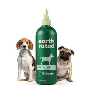 White background with a green bottle of Earth Rated Short Coat Dog Shampoo, additionally on the bottle is text 'White tea & basil, 3 in 1 Dog Shampoo'. A beagle is pictured on the left and a pug is on the right of the bottle. 