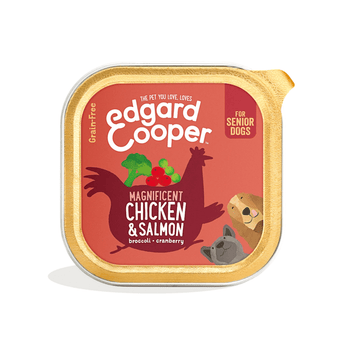 White background with a tray of Edgard and Cooper wet dog food pictured. Text on the foil of the tray says 'Magnificent Chicken & Salmon, broccoli, cranberry.'