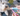 A small white dog looks up while a person holds a pink pet toothbrush and a tube of Virbac Enzymatic pet toothpaste. The background shows a colourful hexagonal patterned rug.