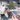A small white dog looks up while a person holds a pink pet toothbrush and a tube of Virbac Enzymatic pet toothpaste. The background shows a colourful hexagonal patterned rug.