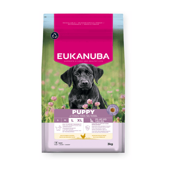 A 3kg bag of Eukanuba Puppy dog food, featuring a black Labrador Retriever on the front of a pink and green bag with purple accents.