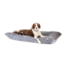 Brown and white Collie Cross lying on a pillow-type grey dog bed with illustrated dogs and a grey fleece underside pictured on a white background. 
