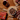 A white bowl filled with Forthglade Just Beef wet dog food pictured on a table with raw ingredients around it, with call outs '90% single source beef plus minerals' and 'mix with dry food'.
