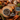 A styled flat-lay of a Forthglade sardine wet dog food ingredient blend on a rustic wooden table, featuring cubed brown meat pieces in a bowl, a whole sardines, carrots, peas, and other ingredients with text overlays reading 'sweet potato & wholesome veg' and '75% single source sardines'.