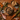 A styled flat-lay of wet dog food ingredients arranged on a wooden table, including a bowl of cubed brown meat, a bowl of brown rice, a raw turkey leg, carrots, peas, herbs, and text callouts reading '75% single source turkey', 'brown rice', and 'wholesome veg'.