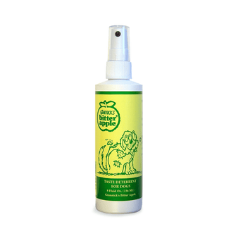 White background with a green spray bottle of Grannick's Bitter Apple Chew Deterrent with an illustrated dog chewing it's own leg on the bottle. 