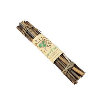 A bundle of natural wooden chew sticks tied together with twine and wrapped in a kraft paper band labelled 'Nature First Willow Sticks'.