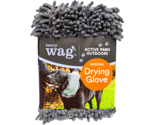Grey microfibre Microfibre Pet Drying Glove in a cardboard sleeve with text 'Henry Wag, Active Paws Outdoors, Microfibre Drying Glove' with a picture of a black Labrador being wiped down with the grooming glove. Pictured on a white background. 